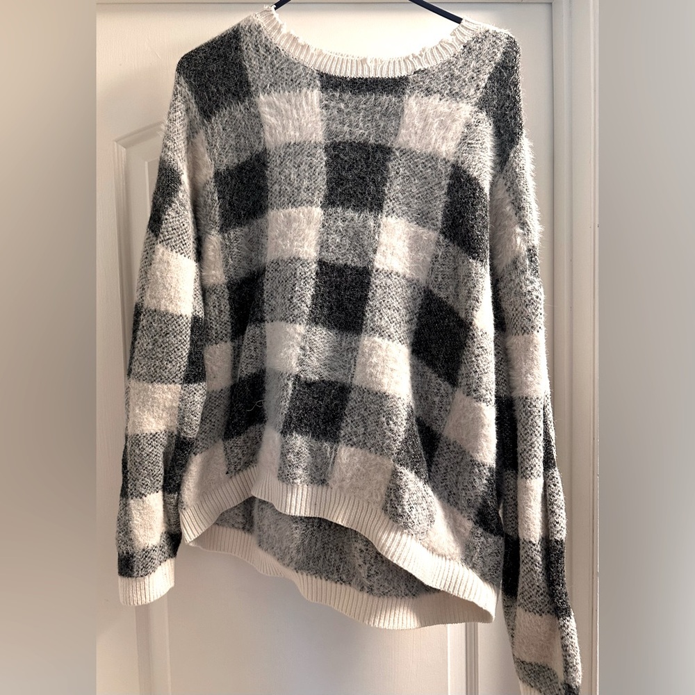 Black and white checkered sweater with frayed neckline